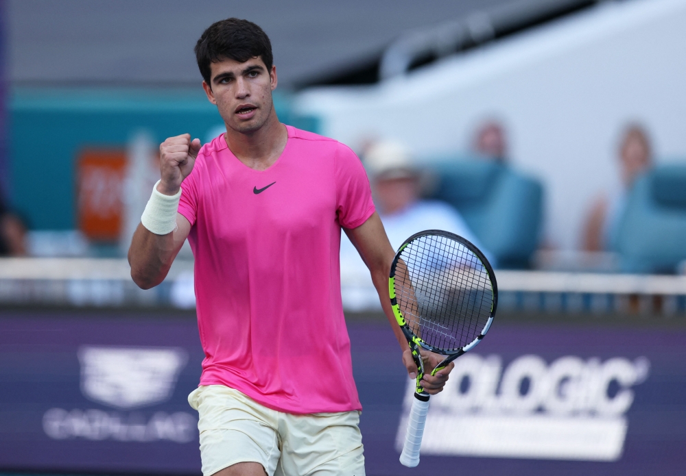 MARCH 26: Carlos Alcaraz of Spain celebrates a point against Dusan Lajovic of Serbia in their third round match at Hard Rock Stadium on March 26, 2023 in Miami Gardens, Florida. Clive Brunskill/Getty Images/AFP 