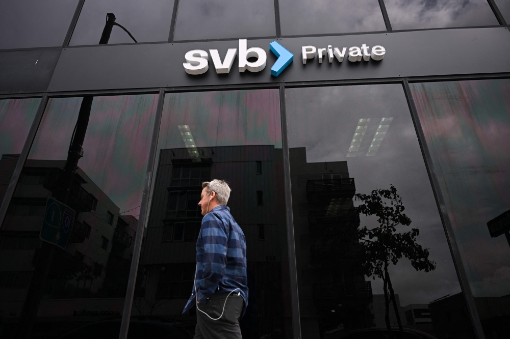 In this file photo taken on March 20, 2023 the SVB Private logo is displayed outside of a Silicon Valley Bank branch in Santa Monica, California.(Photo by Patrick T. Fallon / AFP)