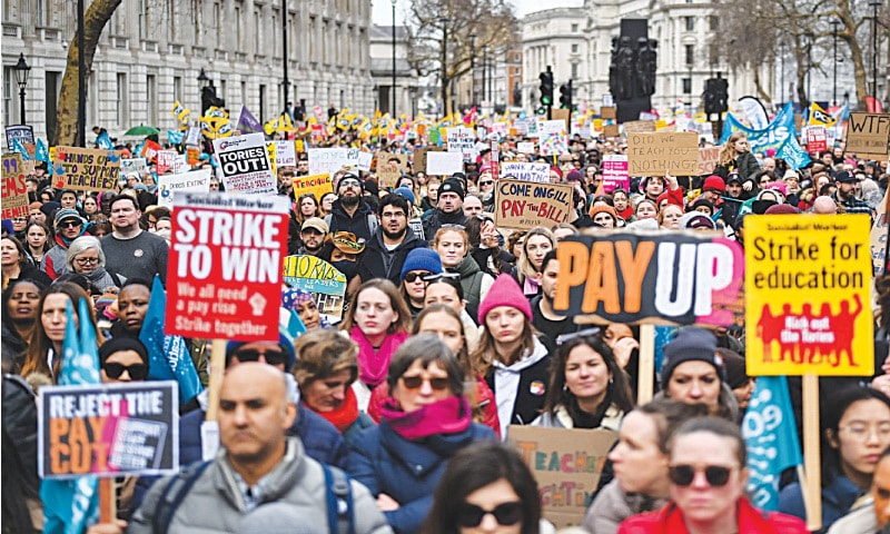 Teachers hold placards and flags during a protest as part of a national strike day in London recently. File photo / AFP