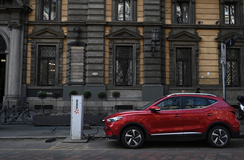 In this file photo taken on March 23, 2023, an MG electric SUV charges at a hub in downtown Milan. Photo by GABRIEL BOUYS / AFP