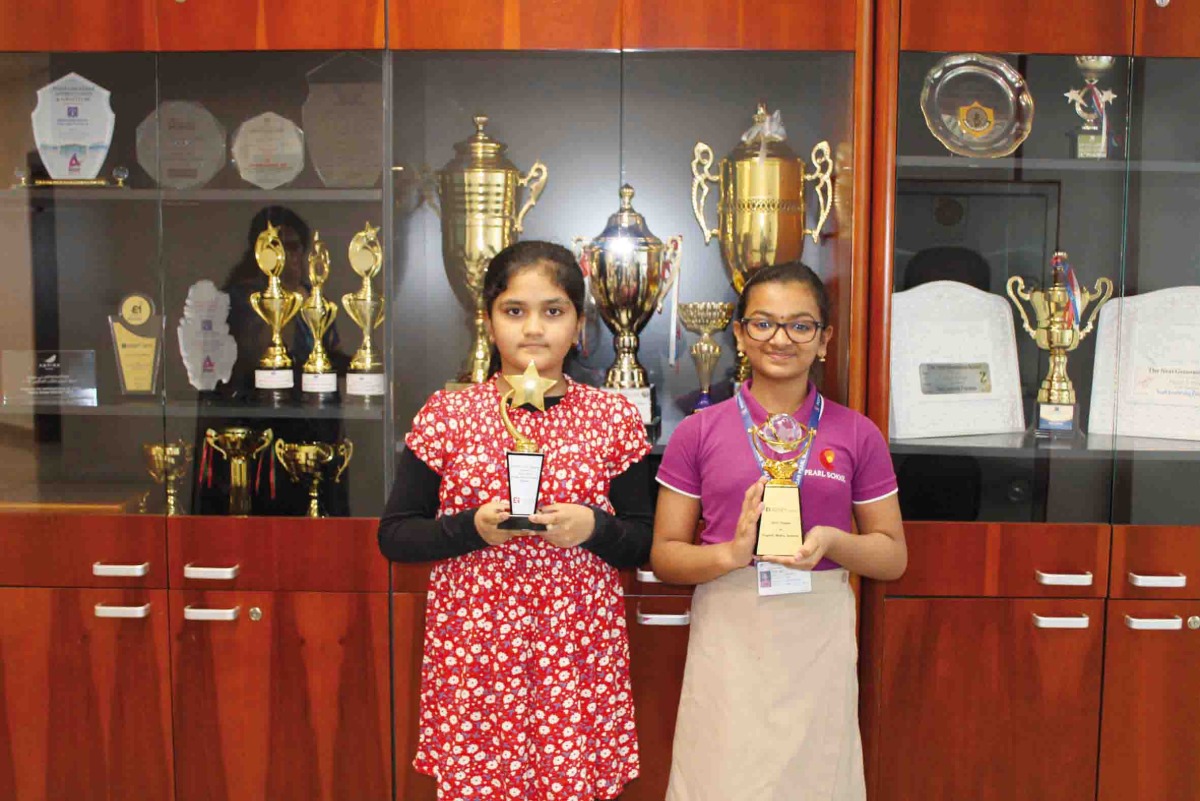 Students with medals and certificates. 
