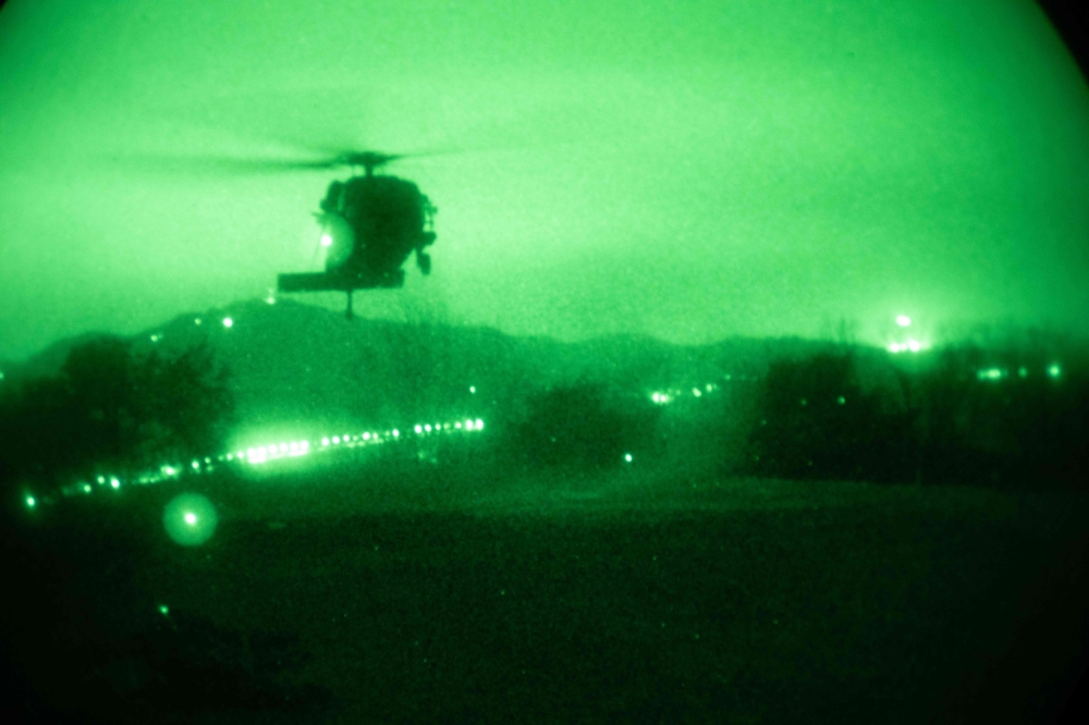 In this handout photo from the US Department of Defense, a Black Hawk helicopter with 2nd Combat Aviation Brigade supports 4-23 Infantry Regiment, 2nd Brigade, 2nd Infantry Division is seen through night vision on March 16, 2023, in the Republic of Korea during Exercise Warrior Shield.  (Photo by Handout / DoD / AFP)
