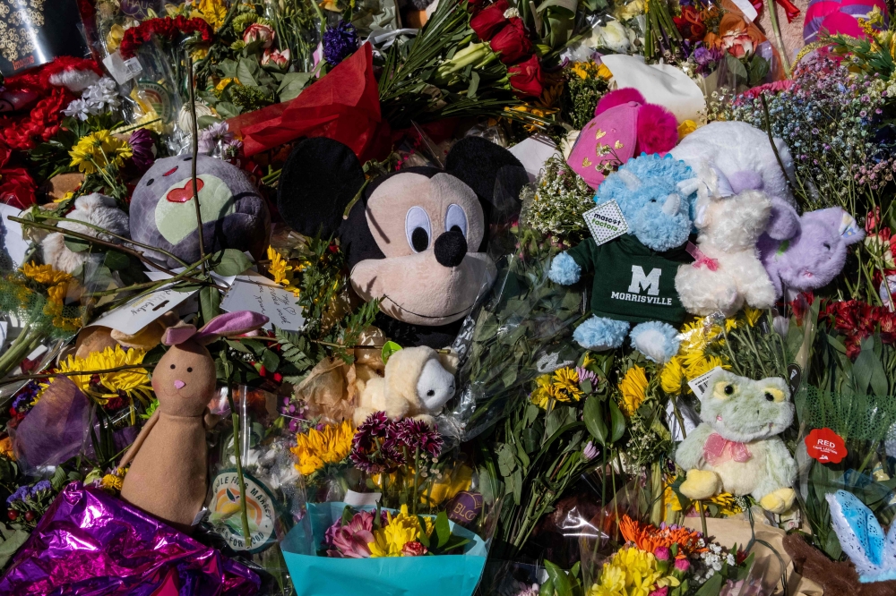 Flowers, balloons, and other items are left at a make shift memorial at the entrance of The Covenant School on April 1, 2023 in Nashville, Tennessee. Photo by Seth Herald / GETTY IMAGES NORTH AMERICA / Getty Images via AFP