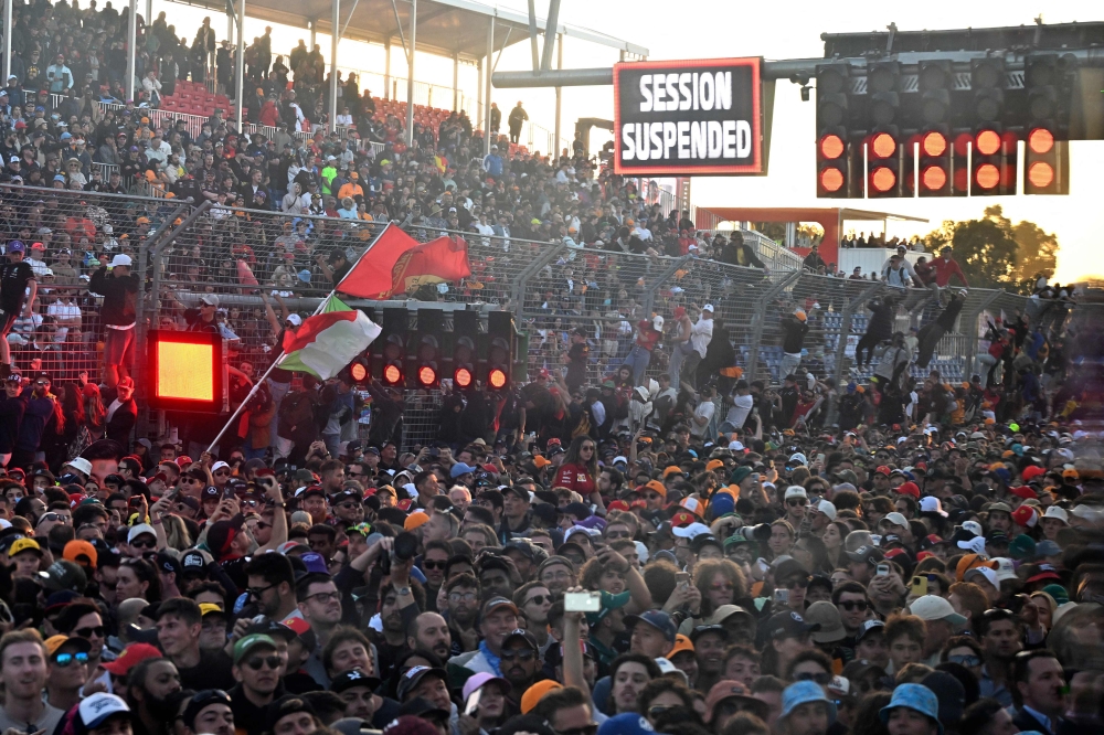 Spectators wait for the race to resume during the 2023 Formula One Australian Grand Prix at the Albert Park Circuit in Melbourne on April 2, 2023. Photo by Paul CROCK / AFP