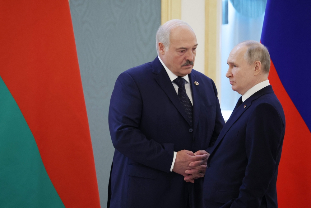 Russian President Vladimir Putin and Belarus's President Alexander Lukashenko are seen prior to talks on union between the two countries at the Kremlin in Moscow on April 6, 2023. (Photo by Mikhail Klimentyev / SPUTNIK / AFP)