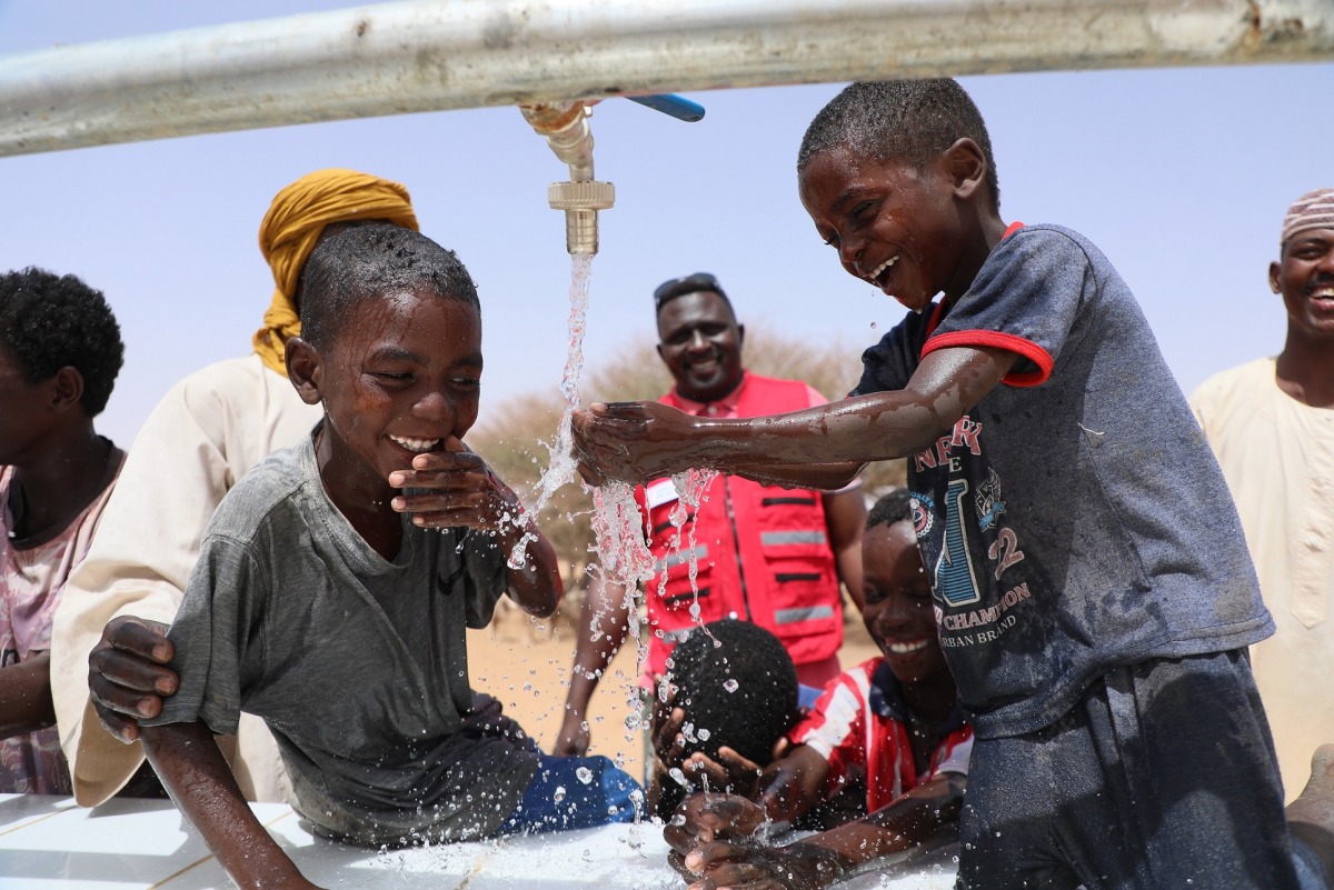 Children at a water project executed by Qatar Red Crescent Society.