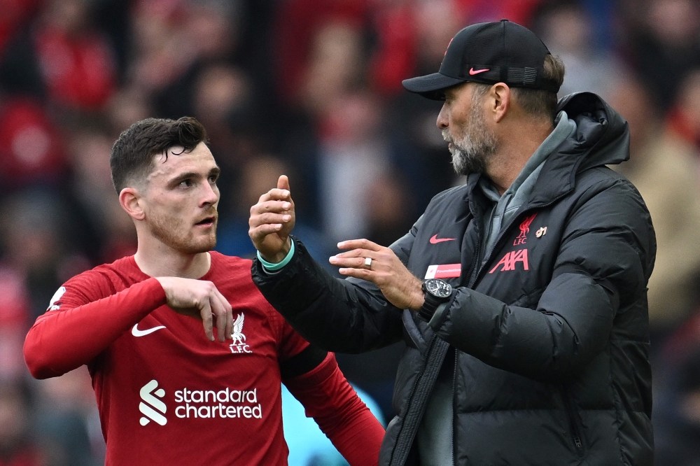 Liverpool's German manager Jurgen Klopp (R) gives instructions to Liverpool's Scottish defender Andrew Robertson during the English Premier League football match between Liverpool and Arsenal at Anfield in Liverpool, north west England on April 9, 2023. (Photo by Paul ELLIS / AFP)