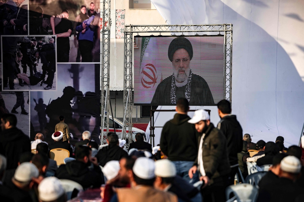 Iran's President Ebrahim Raisi delivers a televised speech during a rally marking Al-Quds (Jerusalem) Day, a commemoration in support of the Palestinian people celebrated annually on the last Friday of the Muslim fasting month of Ramadan, in Gaza City, on April 14, 2023. (Photo by MOHAMMED ABED / AFP)