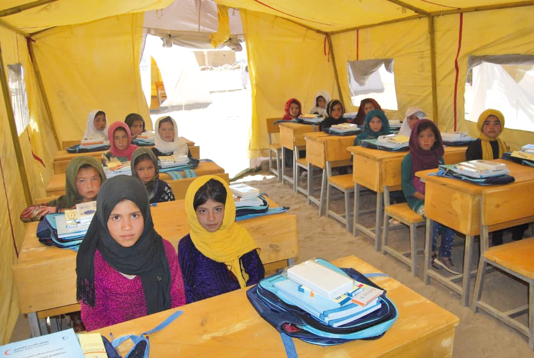Students taking lessons in a facility provided by QRCS under its education support project in Afghanistan.