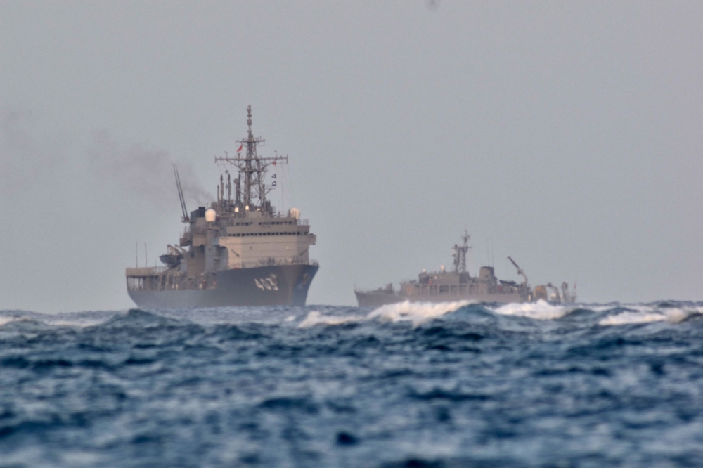 Japan Maritime Self-Defense Force vessels, including the submarine rescue ship Chihaya (L), search the waters off Miyakojima, Okinawa prefecture, where an object believed to be the missing Ground Self-Defense Force UH-60JA helicopter was confirmed, on April 16, 2023. Photo by JIJI Press / AFP