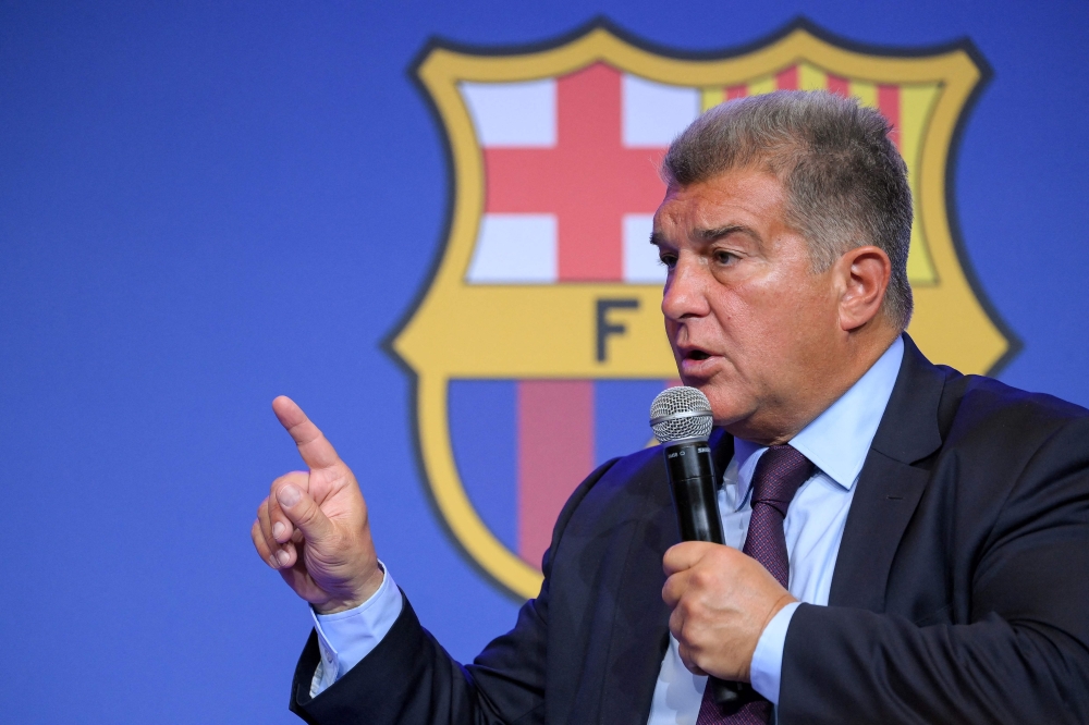 Barcelona's President Joan Laporta presents documents as he addresses a press conference at the Camp Nou stadium in Barcelona on April 17, 2023. Photo by LLUIS GENE / AFP