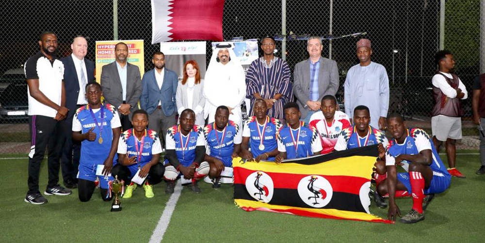 The Ugandan team pose with officials during the closing ceremony. 