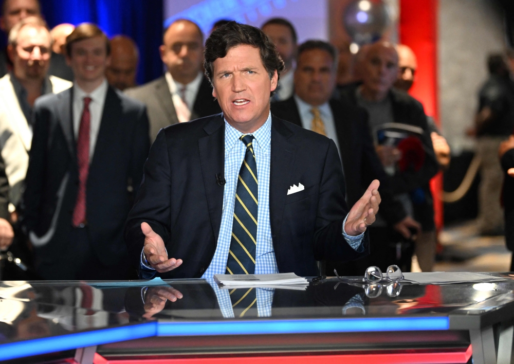 In this file photo taken on November 17, 2022 Tucker Carlson speaks during 2022 FOX Nation Patriot Awards at Hard Rock Live at Seminole Hard Rock Hotel & Casino Hollywood in Hollywood, Florida. (Photo by Jason Koerner / GETTY IMAGES NORTH AMERICA / AFP)
