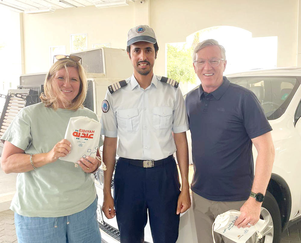 A Customs official poses with tourists at the Abu Samra border.