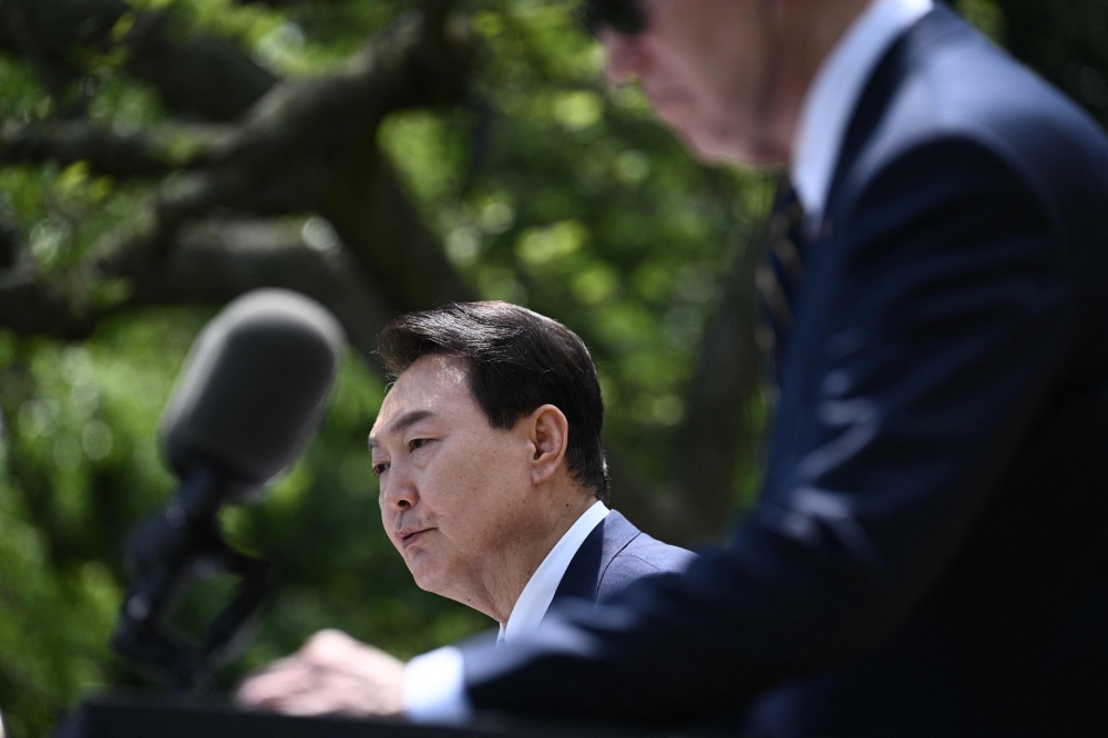 :South Korean President Yoon Suk Yeol speaks during a news conference with US President Joe Biden in the Rose Garden of the White House in Washington, DC, on April 26, 2023. (Photo by Brendan SMIALOWSKI / AFP)
