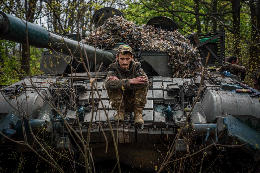 A Ukrainian serviceman sits on his tank at position near the frontline city of Bakhmut, Donetsk region on April 29, 2023, amid the Russian invasion of Ukraine. (Photo by Dimitar Dilkoff / AFP)