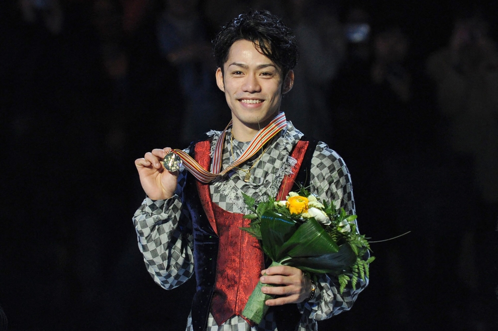 This file photo taken on March 25, 2010 shows gold medallist Japan's Daisuke Takahashi posing with his medal as he celebrates on the podium after winning the men's competition at the World Figure Skating Championships at the Palavela ice-rink in Turin. Photo by Yuri KADOBNOV / AFP
