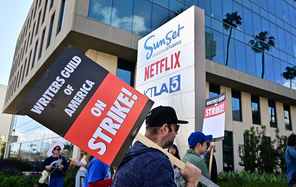 Writers picket in front of Netflix on Sunset Boulevard in Hollywood, California, on May 2, 2023 as the Writers Guild of American (WGA) goes on strike. Photo by Frederic J. BROWN / AFP