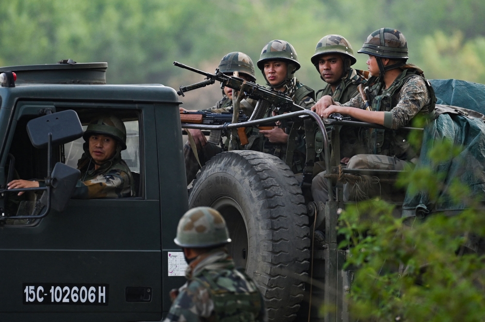 Indian Army servicemen patrol during a rescue operation following ethnic violence in the region, near Imphal, northeastern Indian state of Manipur on May 7, 2023. (Photo by Arun Sankar / AFP)
