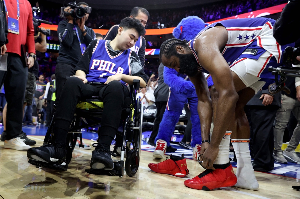 James Harden #1 of the Philadelphia 76ers gives his game sneakers to Michigan State shooting survivor John Hao after defeating the Boston Celtics in game four of the Eastern Conference Second Round Playoffs at Wells Fargo Center on May 07, 2023 in Philadelphia, Pennsylvania. (Photo by Tim Nwachukwu / GETTY IMAGES NORTH AMERICA / Getty Images via AFP)
