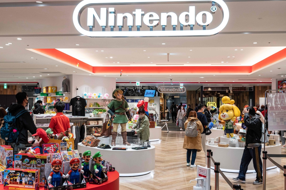 This photo taken on May 8, 2023 shows the logo (top) for Japanese gaming giant Nintendo at the entrance to company's official store in Tokyo's Shibuya district. Photo by Richard A. Brooks / AFP