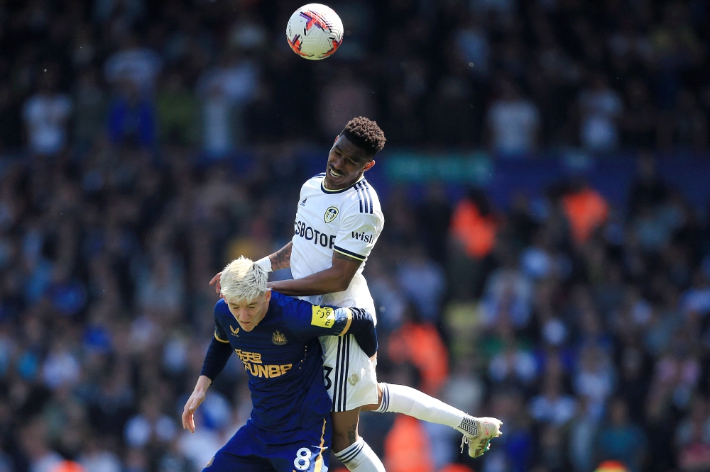 Leeds United's Spanish defender Junior Firpo heads the ball with Newcastle United's English midfielder Anthony Gordon (L) during the English Premier League football match between Leeds United and Newcastle United at Elland Road in Leeds, northern England on May 13, 2023. (Photo by Lindsey Parnaby / AFP) 