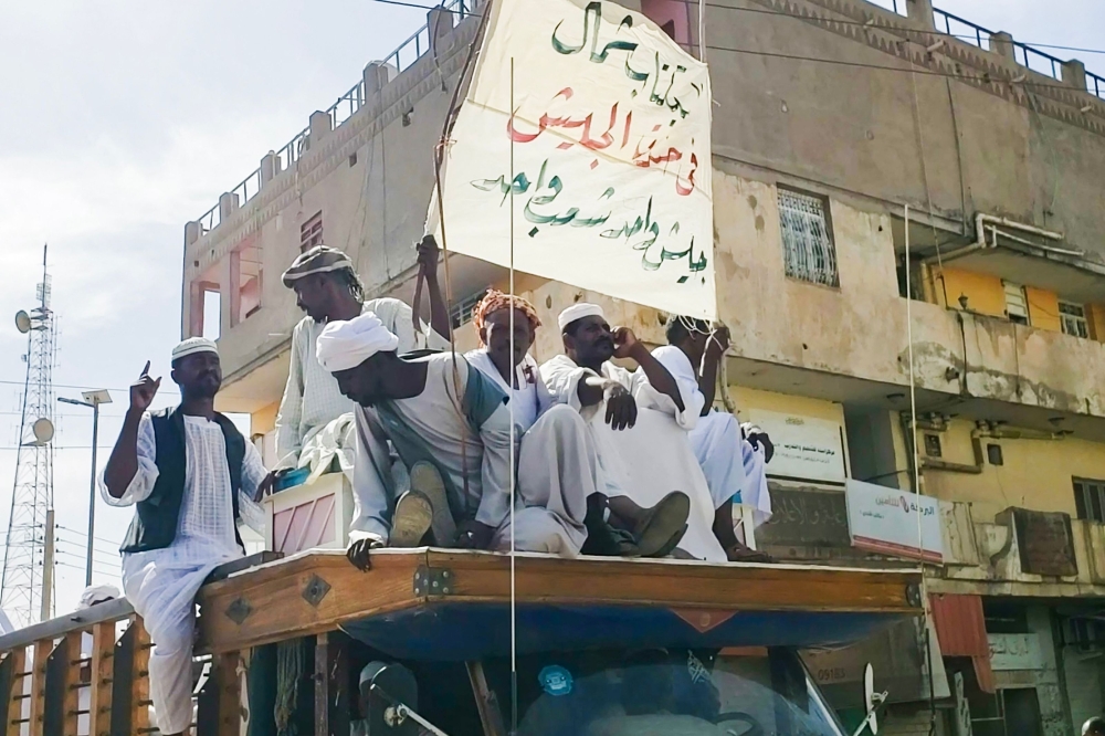 People form a convoy as they celebrate in support of the Sudanese armed forces in Khartoum on May 12, 2023, as violence between the forces of two rival Sudanese generals continues. (Photo by AFP)