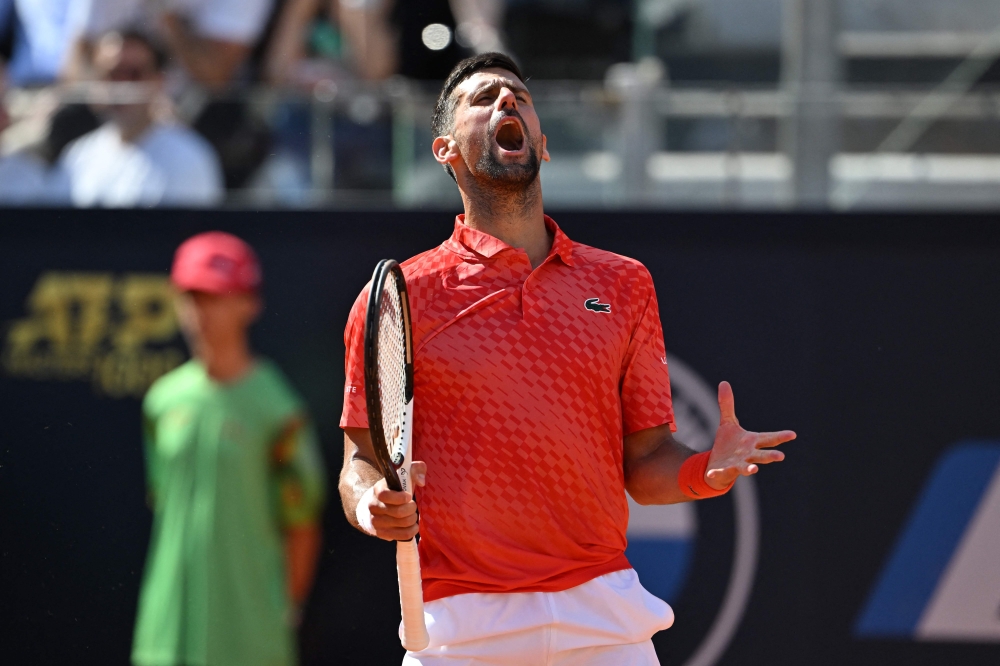Serbia's Novak Djokovic reacts during his third round match against Bulgaria's Grigor Dimitrov at the Men's ATP Rome Open tennis tournament at Foro Italico in Rome on May 14, 2023. (Photo by Tiziana FABI / AFP)