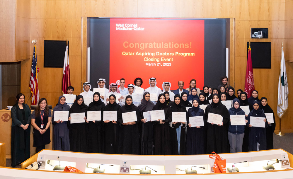 The successful students with their certificates of completion during a ceremony.
