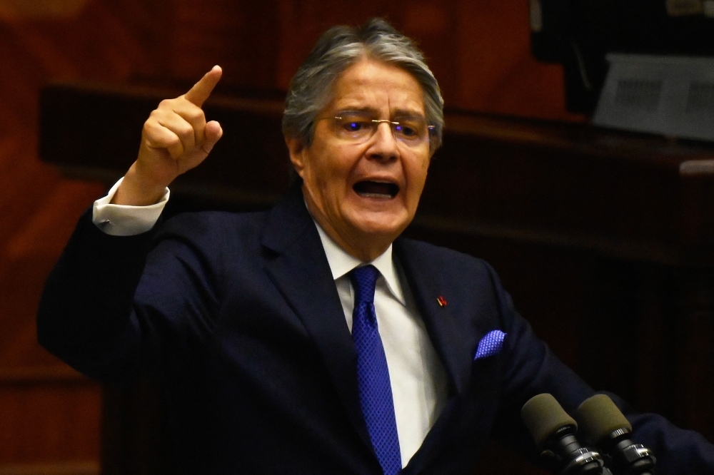 Ecuador's President Guillermo Lasso speaks during his political trial at the National Assembly headquarters in Quito on May 16, 2023. (Photo by Rodrigo Buendia / AFP)