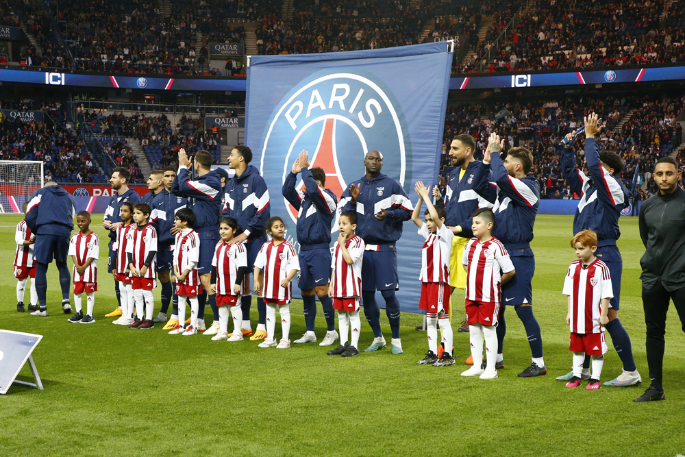 PSG football players with children at the Parc des Princes stadium