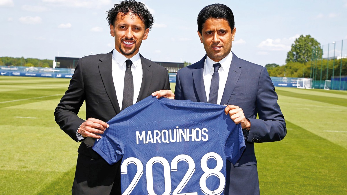 Paris Saint-Germain President and CEO Nasser bin Ghanim Al Khelaifi and captain Marquinhos hold a team jersey after the Brazilian defender's contract was extended until 2028. PIC: PSG