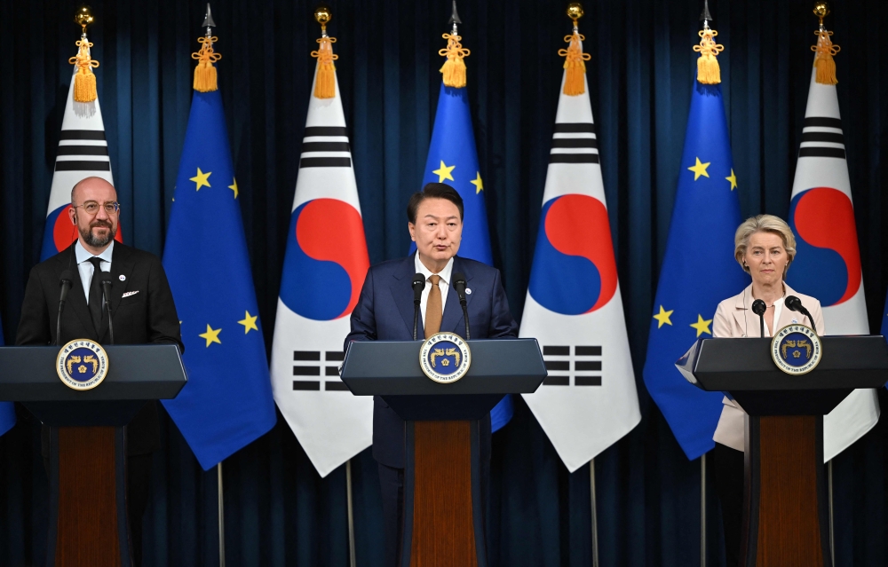South Korea's President Yoon Suk Yeol (C) speaks as Charles Michel (L), President of the European Council, and Ursula von der Leyen (R), President of the European Commission, look on during a joint press briefing after their meeting at the Presidential Office in Seoul on May 22, 2023. Photo by JUNG YEON-JE / POOL / AFP