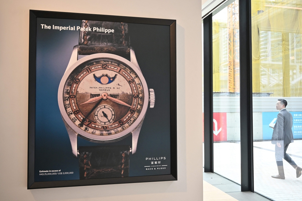 A poster of the Patek Philippe Ref 96 Quantieme Lune timepiece, once owned by Aisin-Gioro Puyi, the Chinese Qing dynasty’s last emperor, is seen on display in Phillips auction house in Hong Kong on May 23, 2023 ahead of its auction in the territory on the same day. (Photo by Peter Parks / AFP)