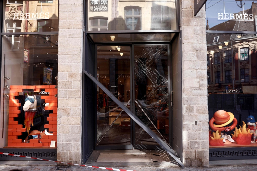 This photograph taken on May 25, 2023 in Lille shows the outside of the Hermes luxury store on the prestigious rue Grande-Chaussee where robbers used a car to ram the security gate and gain entry into the store. Photo by Sameer Al-Doumy / AFP
