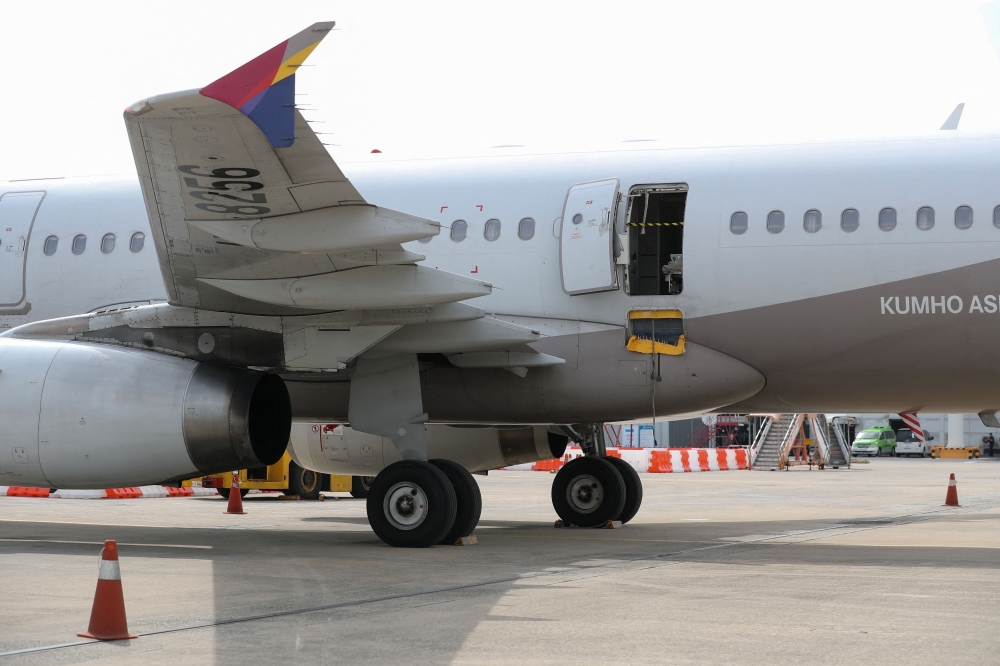An opened door of an Asiana Airlines plane is seen at Daegu International Airport in Daegu on May 26, 2023, after it was manually opened by a passenger just 200 metres above the ground before landing causing some to have breathing difficulty but with no major injuries.
