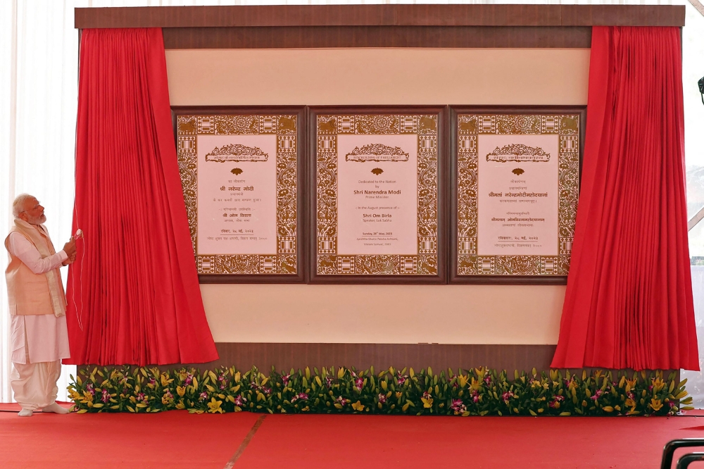 This handout photograph taken on May 28, 2023, and released by the Indian Press Information Bureau (PIB) shows India's Prime Minister Narendra Modi inaugurating the new parliament building in New Delhi. (Photo by PIB / AFP)