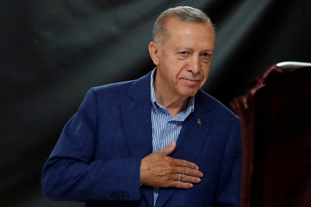 Turkey's President and presidential candidate of AK Party Recep Tayyip Erdogan gestures at the polling station on the day of the Presidential runoff vote in Istanbul on May 28, 2023. (Photo by MURAD SEZER / POOL / AFP)
