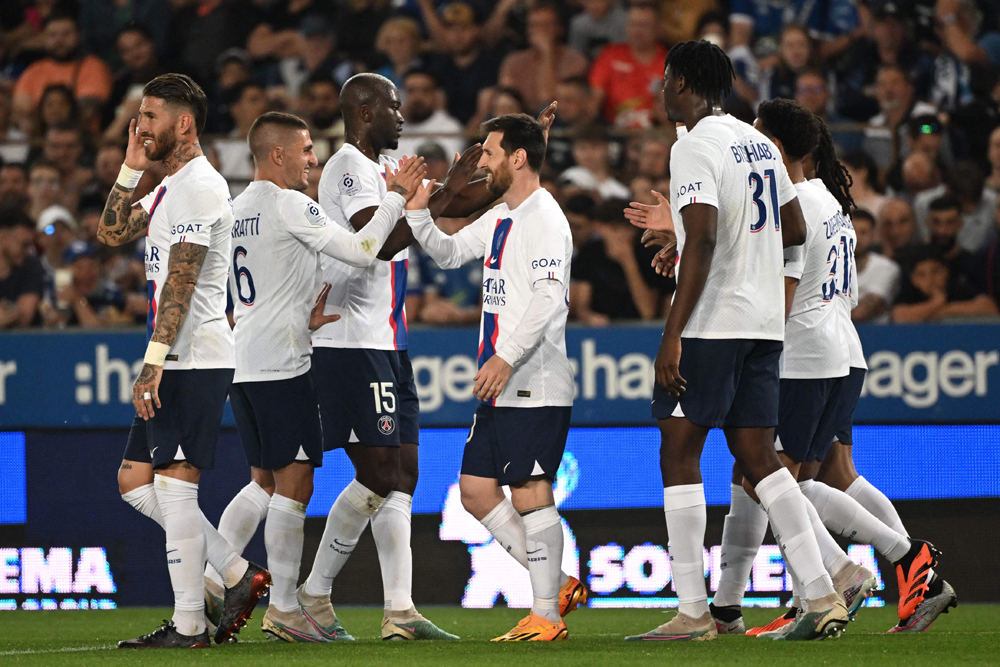 PSG's Lionel Messi (centre) celebrates with teammates after scoring a goal against RC Strasbourg Alsace. AFP