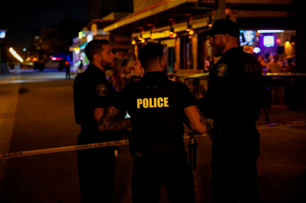 MAY 29: Law enforcement officers are seen on a crime scene as they respond to a shooting at Hollywood Beach on May 29, 2023 in Hollywood, Florida. Photo by Eva Marie Uzcategui / Getty Images North America / Getty Images via AFP