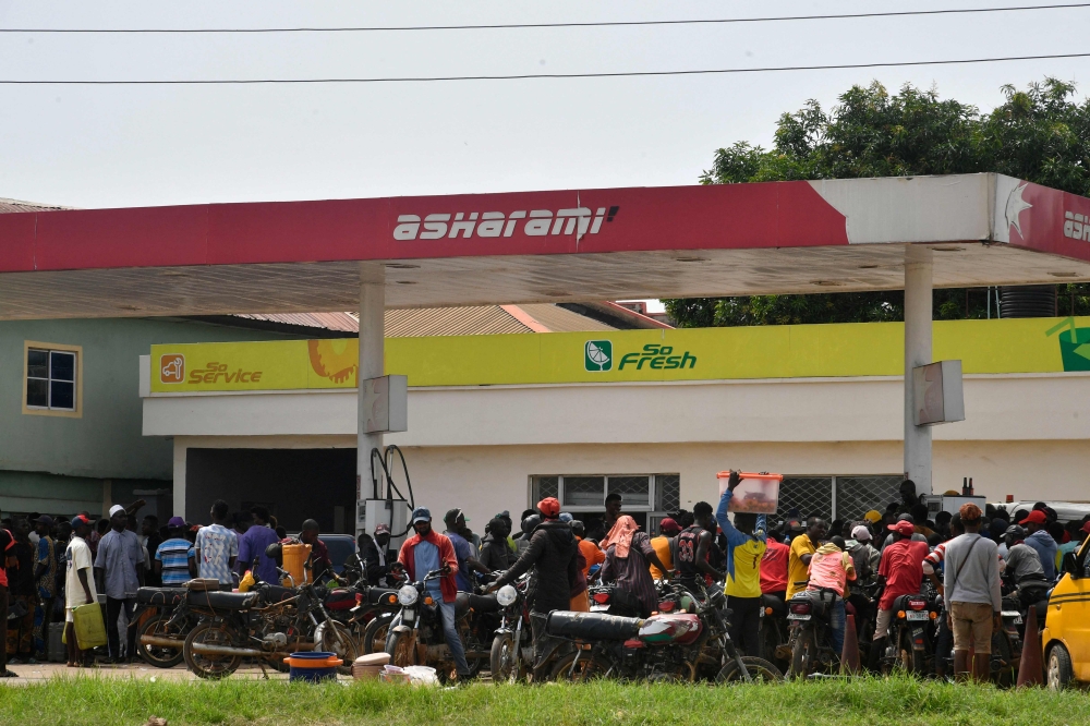 Motorbike taxis converge to buy fuel at a petrol station at Ibafo, Ogun State in southwest Nigeria, on May 30, 2023. (Photo by PIUS UTOMI EKPEI / AFP)
