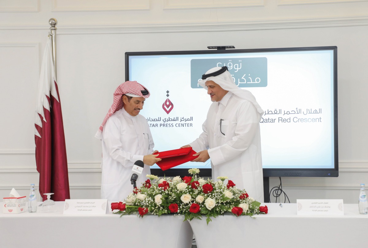 President of QRCS Yousef bin Ali Al Khater and President of Qatar Press Center H E Saad bin Mohammed Al Rumaihi at the signing ceremony.