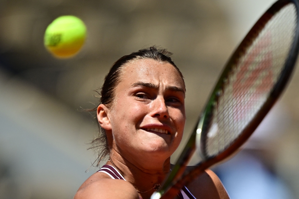 Belarus' Aryna Sabalenka plays a backhand return to Russia's Kamilla Rakhimova during their women's singles match on day six of the Roland-Garros Open tennis tournament at the Court Philippe-Chatrier in Paris on June 2, 2023. (Photo by Julien De Rosa / AFP)