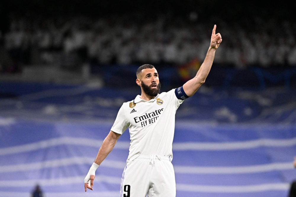 Real Madrid's French forward Karim Benzema celebrates scoring his team's first goal during the UEFA Champions League quarter final first leg football match between Real Madrid CF and Chelsea FC at the Santiago Bernabeu stadium in Madrid on April 12, 2023. Photo by JAVIER SORIANO / AFP