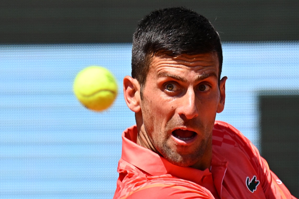 Serbia's Novak Djokovic eyes the ball as he plays against Peru's Juan Pablo Varillas during their men's singles match on day eight of the Roland-Garros Open tennis tournament at the Court Philippe-Chatrier in Paris on June 4, 2023. Photo by Emmanuel DUNAND / AFP