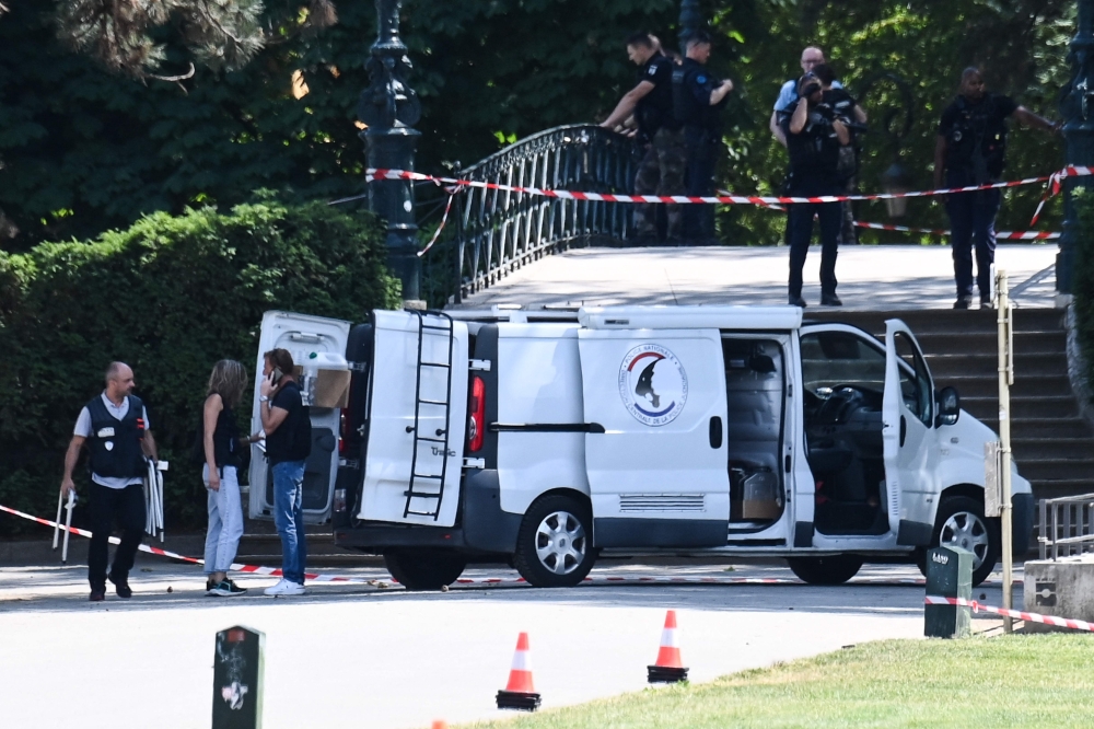 Investigators of the judicial police work at the scene of a stabbing attack in a the 'Jardins de l'Europe' parc in Annecy, French Alps, on June 8, 2023. Photo by OLIVIER CHASSIGNOLE / AFP