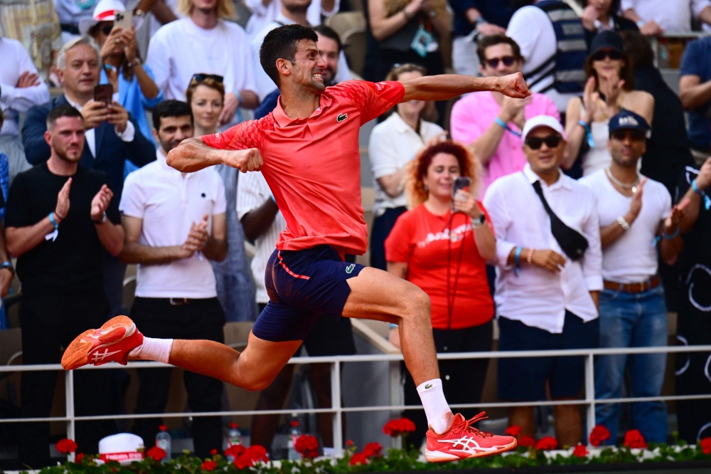 Serbia's Novak Djokovic celebrates his victory over Norway's Casper Ruud during their men's singles final match on day fifteen of the Roland-Garros Open tennis tournament at the Court Philippe-Chatrier in Paris on June 11, 2023. (Photo by Emmanuel Dunand / AFP)