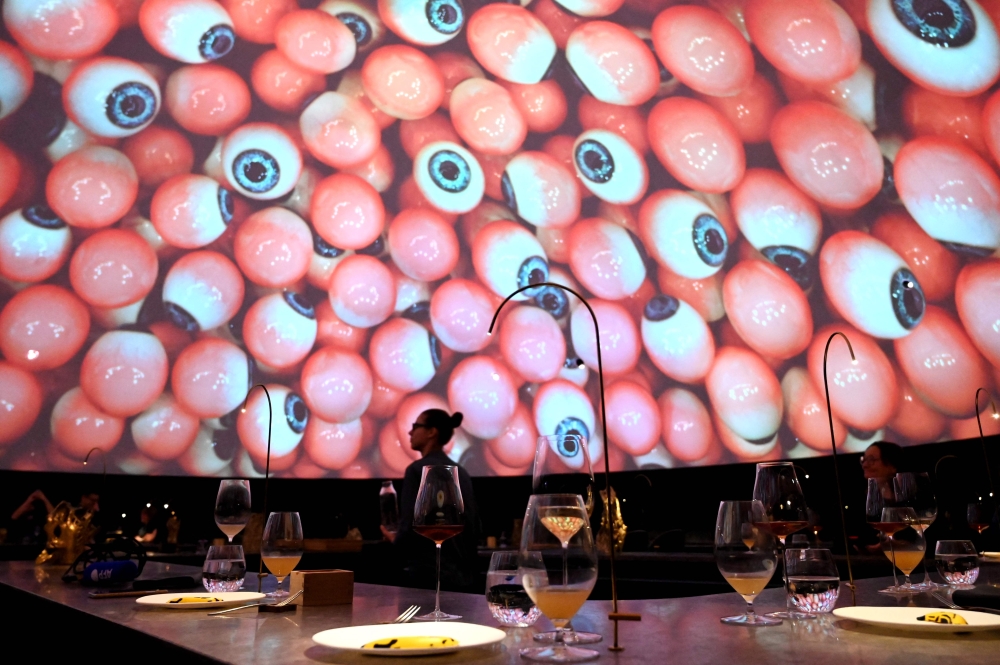 A waiter serves the food at the Alchemist restaurant in Copenhagen, Denmark, on May 25, 2023. (Photo by Sergei Gapon / AFP) 