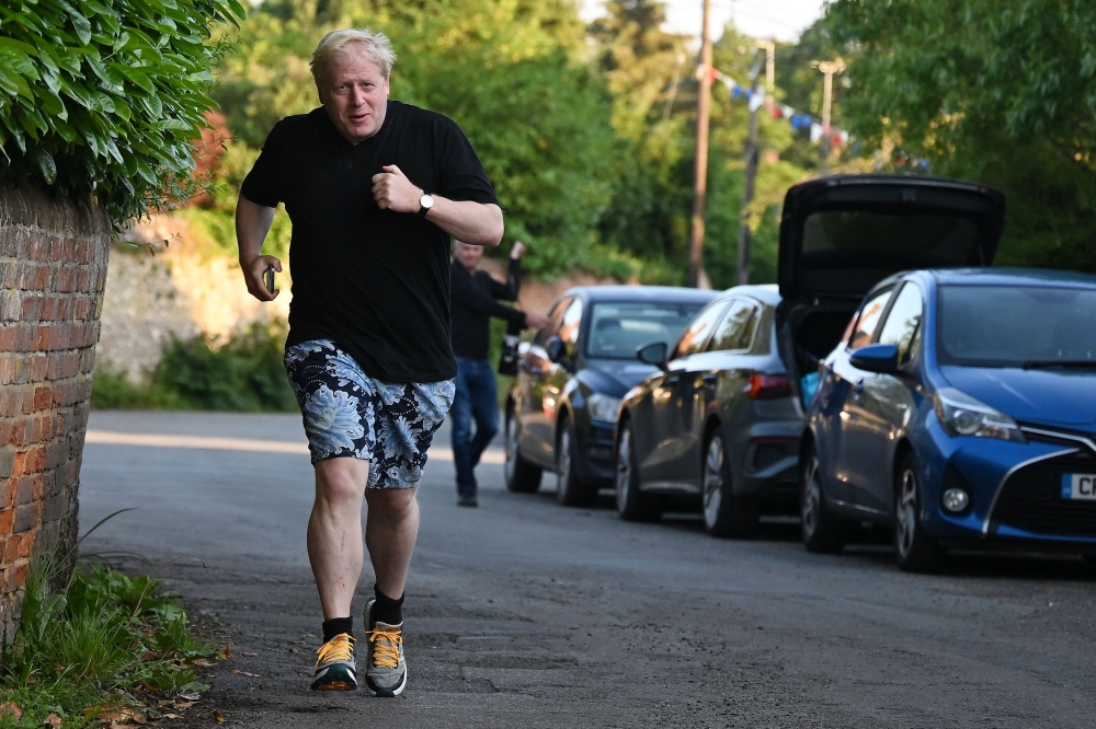 Former British Prime Minister Boris Johnson leaves his house for a run in Brightwell-cum-Stowell, west of London on June 14 2023. (Photo by Justin Tallis / AFP)