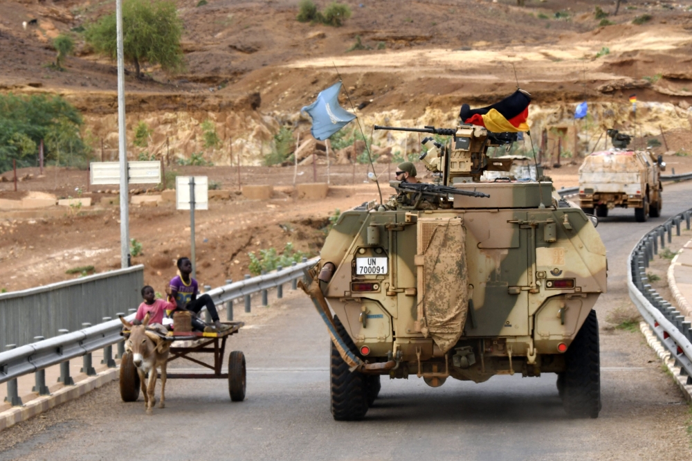 In this file photo taken on August 03, 2018, German soldiers from the parachutists detachment of the MINUSMA (United Nations Multidimensional Integrated Stabilization Mission in Mali) cross the Niger river bridge during a patrol searching for IED (improvised explosive device) on the route from Gao to Gossi, Mali. (Photo by SEYLLOU / AFP)